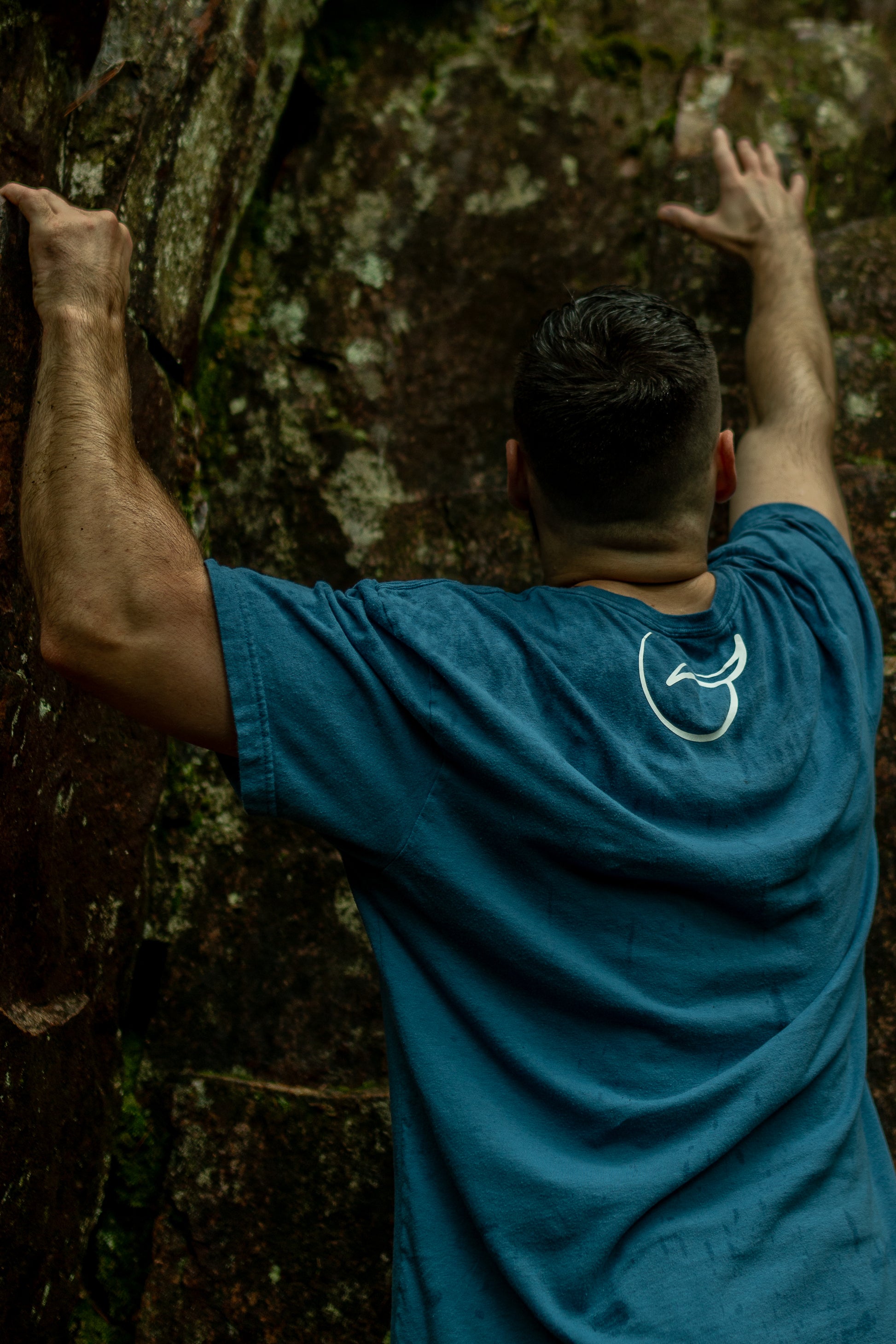 Back of light blue t shirt made from 100% Organic Cotton displaying the Breath brand name across the front with the logo on the back.