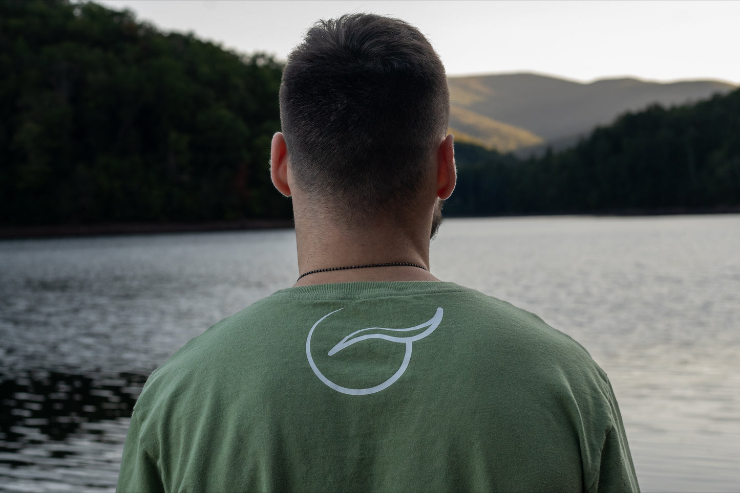 Upper Back of 100% organic cotton light mint green t-shirt with logo on the back and Breath across the front.