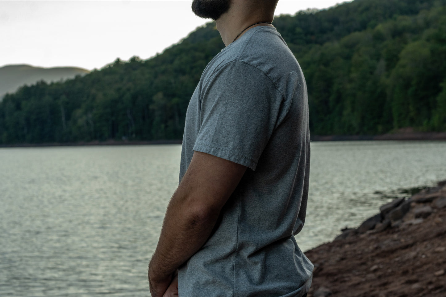 Side view of a grey short sleeve t shirt made from 50/50 recycled cotton and polyester.