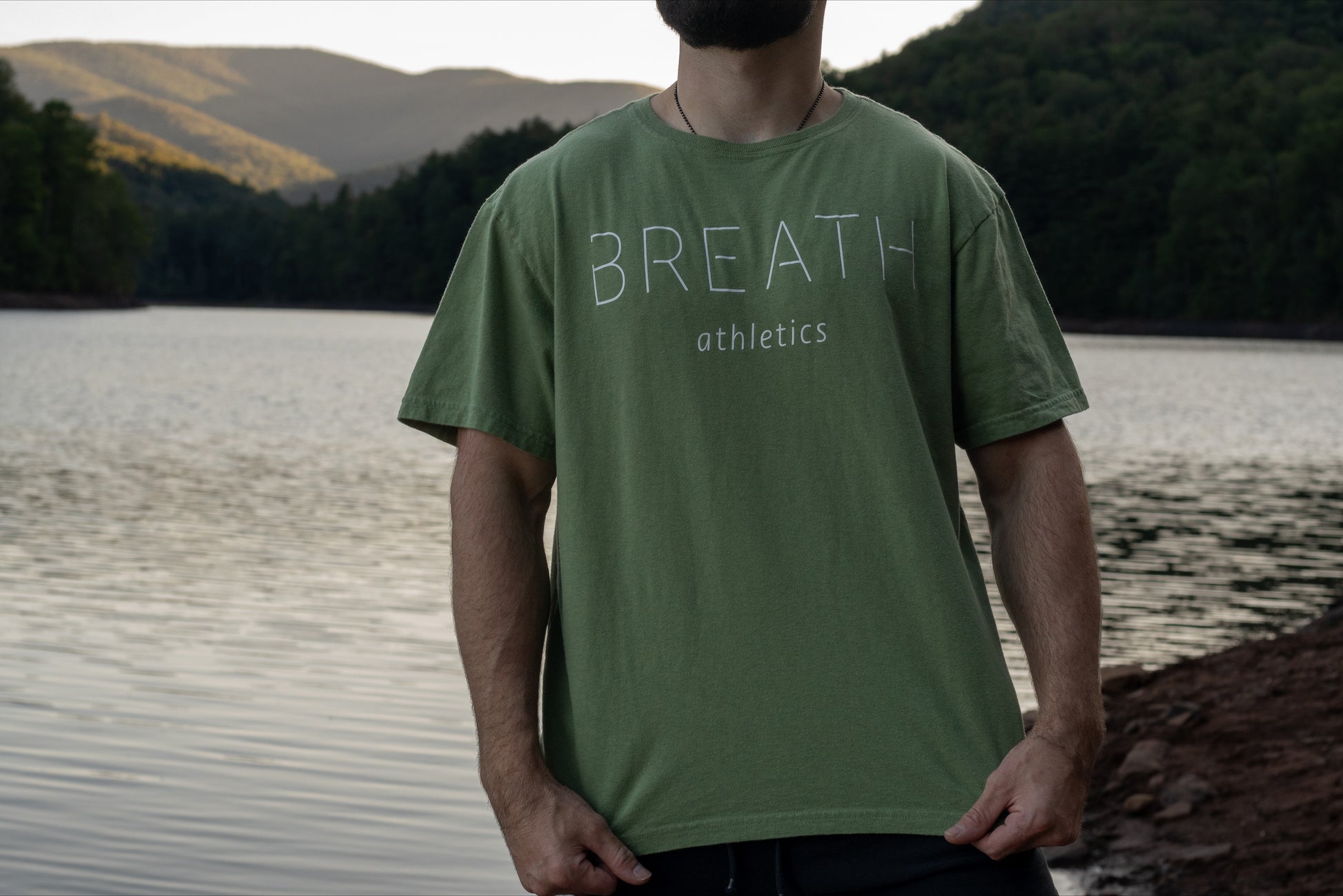 Front of 100% organic cotton light mint green t-shirt with logo on the back and Breath across the front.